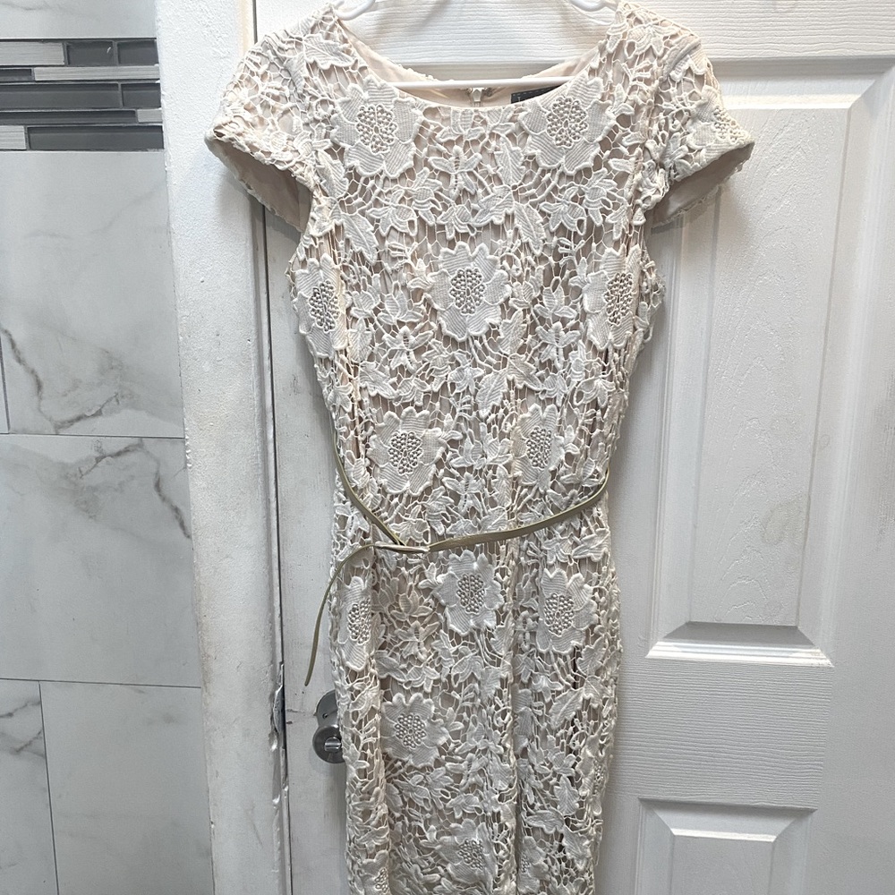Cream colored Luxology dress size 6 very detail knee length w slim gold belt.